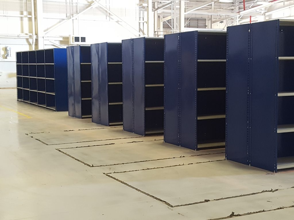 Blue shelving in a workplace.