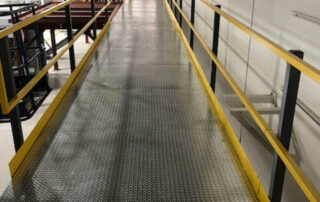 Work platform with yellow rails that helps in choosing your warehouse partner.