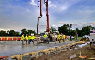 Single Source Systems team in bright yellow shirts at a general contracting job site. Contact us today.