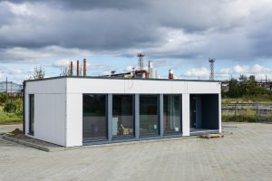 A white modular office that is one of many types of metal buildings with commercial use and industrial spaces.