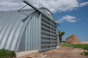 A silver quonset hut which is one of many types of metal buildings