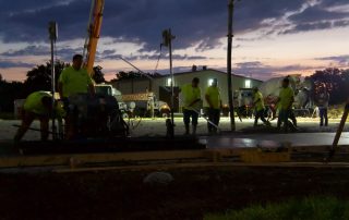 Workers and subcontractors on a general contracting project at night