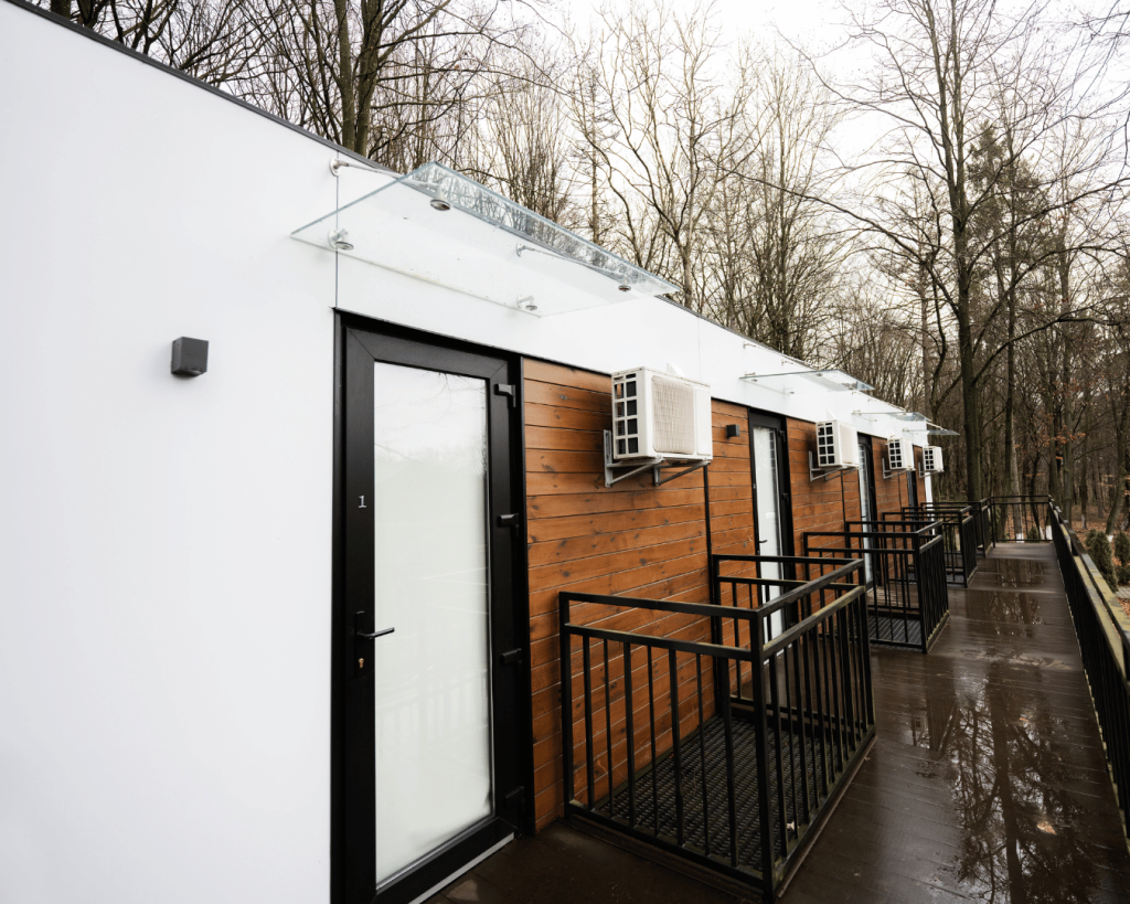 White modular office with wood panels on a rainy day