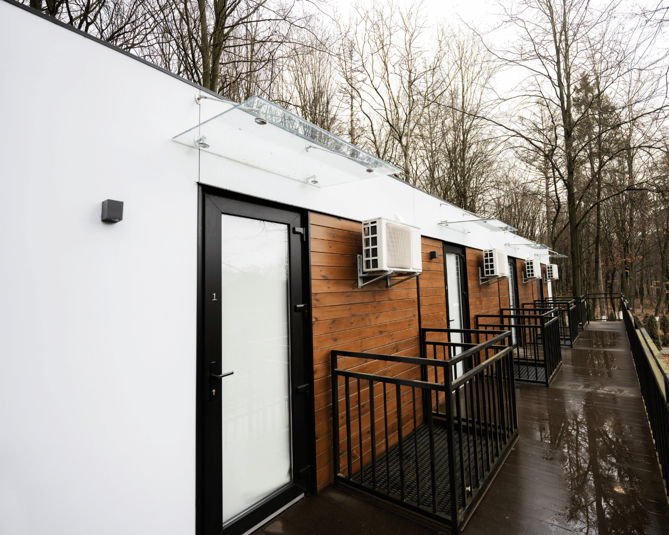 White modular offices with wood panels on a rainy day