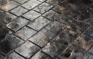 Dark stamped concrete - one of several types of decorative concrete.