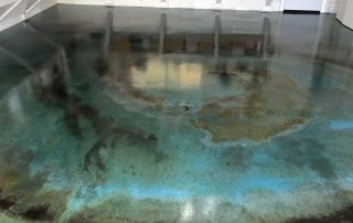 Blue and grey concrete floor with acid staining.